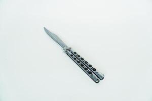 Partially open silver balisong or butterfly knife isolated on white background. Close-up of a sharp balisong knife or butterfly knife in various positions on a white background photo