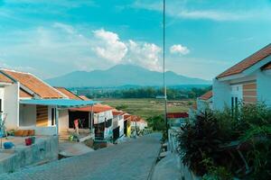 Residential area with beautiful views with a backdrop of green rice fields and mountains that look magnificent from a distance. Public housing complex on hills with sloping land with mountain views photo