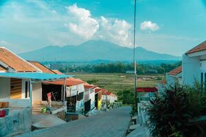 Residential area with beautiful views with a backdrop of green rice fields and mountains that look magnificent from a distance. Public housing complex on hills with sloping land with mountain views photo
