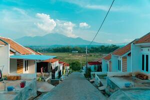 Residential area with beautiful views with a backdrop of green rice fields and mountains that look magnificent from a distance. Public housing complex on hills with sloping land with mountain views photo