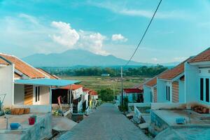 Residential area with beautiful views with a backdrop of green rice fields and mountains that look magnificent from a distance. Public housing complex on hills with sloping land with mountain views photo