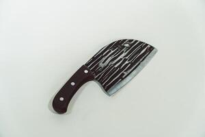 Close up of an adventure and bushcraft knife using a wooden handle. Knife with a sharp stainless steel blade with a wooden handle, perfect for outdoor adventures and bushcraft activities photo