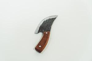 Close up of an adventure and bushcraft knife using a wooden handle. Knife with a sharp stainless steel blade with a wooden handle, perfect for outdoor adventures and bushcraft activities photo