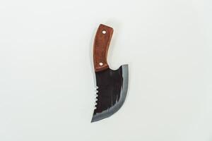 Close up of an adventure and bushcraft knife using a wooden handle. Knife with a sharp stainless steel blade with a wooden handle, perfect for outdoor adventures and bushcraft activities photo