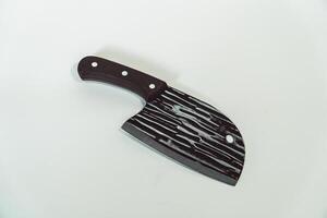 Close up of an adventure and bushcraft knife using a wooden handle. Knife with a sharp stainless steel blade with a wooden handle, perfect for outdoor adventures and bushcraft activities photo