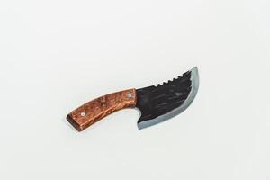 Close up of an adventure and bushcraft knife using a wooden handle. Knife with a sharp stainless steel blade with a wooden handle, perfect for outdoor adventures and bushcraft activities photo