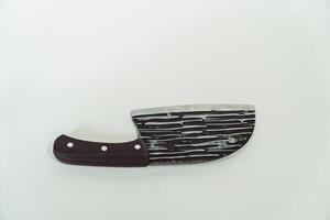 Close up of an adventure and bushcraft knife using a wooden handle. Knife with a sharp stainless steel blade with a wooden handle, perfect for outdoor adventures and bushcraft activities photo