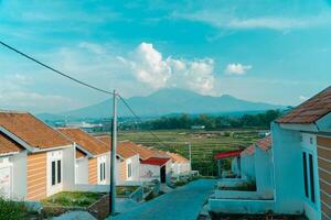 Residential area with beautiful views with a backdrop of green rice fields and mountains that look magnificent from a distance. Public housing complex on hills with sloping land with mountain views photo