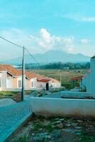 Residential area with beautiful views with a backdrop of green rice fields and mountains that look magnificent from a distance. Public housing complex on hills with sloping land with mountain views photo