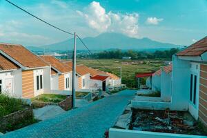 Residential area with beautiful views with a backdrop of green rice fields and mountains that look magnificent from a distance. Public housing complex on hills with sloping land with mountain views photo