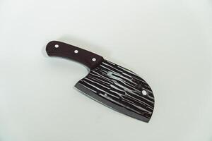 Close up of an adventure and bushcraft knife using a wooden handle. Knife with a sharp stainless steel blade with a wooden handle, perfect for outdoor adventures and bushcraft activities photo