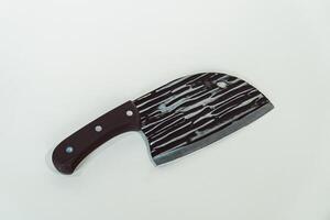 Close up of an adventure and bushcraft knife using a wooden handle. Knife with a sharp stainless steel blade with a wooden handle, perfect for outdoor adventures and bushcraft activities photo
