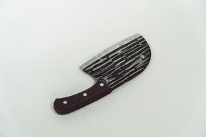 Close up of an adventure and bushcraft knife using a wooden handle. Knife with a sharp stainless steel blade with a wooden handle, perfect for outdoor adventures and bushcraft activities photo