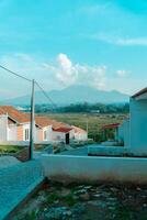 Residential area with beautiful views with a backdrop of green rice fields and mountains that look magnificent from a distance. Public housing complex on hills with sloping land with mountain views photo