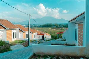Residential area with beautiful views with a backdrop of green rice fields and mountains that look magnificent from a distance. Public housing complex on hills with sloping land with mountain views photo