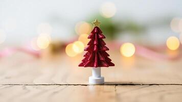 Miniature Christmas Tree With Gold Star On Wooden Table With Bokeh Background photo
