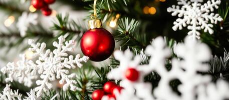 Red Christmas Ornament and White Snowflakes on a Christmas Tree photo