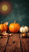 Pumpkins and fall leaves on rustic wooden table photo