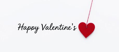 Happy Valentine's Day - Red Heart Hanging from String on White Background photo