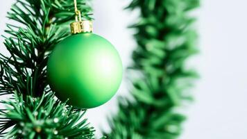 Green Christmas Ornament on Christmas Tree Branch photo