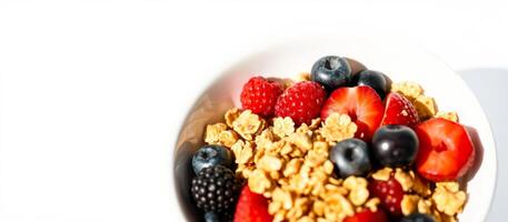 Closeup of a bowl of granola, berries, and sliced strawberries photo