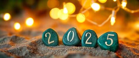 teal stones spell out the year 2025 against a golden light backdrop photo