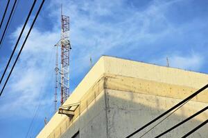 Telecom Pole on Roofs with Blue Sky. photo