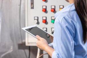 Engineer using Tablet software check service maintenance electricity main circuit fuse and power system in industry factory photo