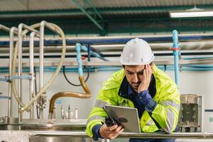 Tires Stress Engineer worker overtime working. Having problem feeling stressed and headache when looking at tablet machine monitor screen. photo