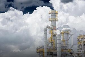 Oil petroleum refinery plant building distillation columns tower, Closeup part of fuel gas pipe complex, Crude oil petrochemical industrial building. photo