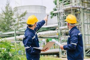 Engineer worker team working outdoor, Surveyor teamwork survey gas pipe oil transport pipeline deploy building project for refinery industry. photo