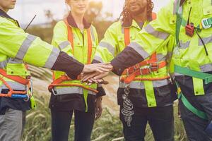 Group of Engineer team workers hand join together working cooperation strong force teamwork powerful concept. photo