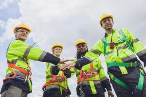 Group of Engineer team workers hand join together working cooperation strong force teamwork powerful concept. photo