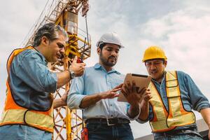 Workers team working together with contractor at construction site. Engineer project teamwork people concept. photo