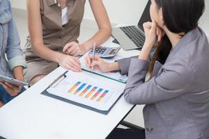 Business women talking with team in office room, Marketing secretary work on the table with manager present information to deciding photo