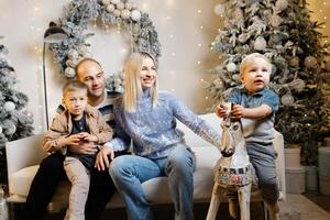 Family enjoys christmas morning, opening presents and laughing together photo