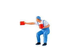 A miniature figurine of a painter holding a paint can and brush isolate on white background with clipping path photo