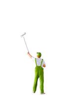 A miniature figurine of a painter holding a long-handled roller brush, isolated on white background with clipping path photo