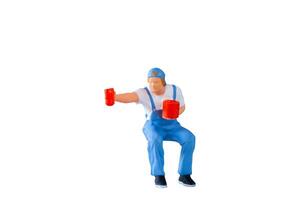 A miniature figurine of a painter holding a paint can and brush isolate on white background with clipping path photo