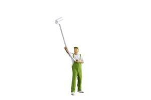 A miniature figurine of a painter holding a long-handled roller brush, isolated on white background with clipping path photo
