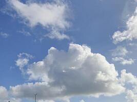 Cumulus Clouds Under an Azure Sky with Street Light photo