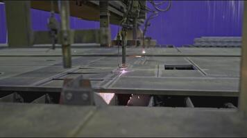 Automated welding machine at factory. Stock clip. Laser machine that cuts metal plates. Metalworking machine with welding in industrial production video
