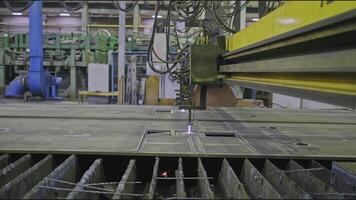 Automated welding machine at factory. Stock clip. Laser machine that cuts metal plates. Metalworking machine with welding in industrial production video