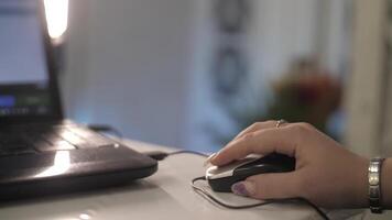 Click black computer mouse on a work desk. Working with a PC or laptop at workplace, close-up video