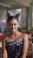 A Playful Woman Making a Funny Face While Sitting in a Trendy and Vibrant Setting video
