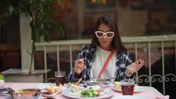 Enjoying a Dining Experience with a Stylish Woman Wearing Chic Sunglasses and Smiling video