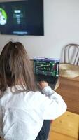 A person is diligently working on their laptop while sitting at a cozy and inviting desk video
