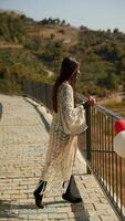 A Young Woman Enjoying a Beautiful Day at the Scenic Overlook with a Colorful Beach Ball video