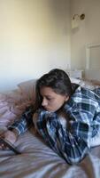 Enjoying a Relaxing Moment on the Bed with a Phone in Hand While Embracing Serenity and Tranquility video