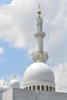 The white dome with one tall minaret in the background photo